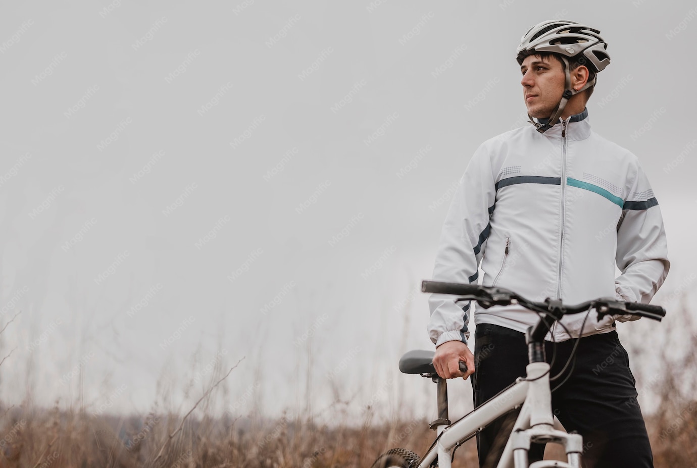A person standing next to a bicycleDescription automatically generated